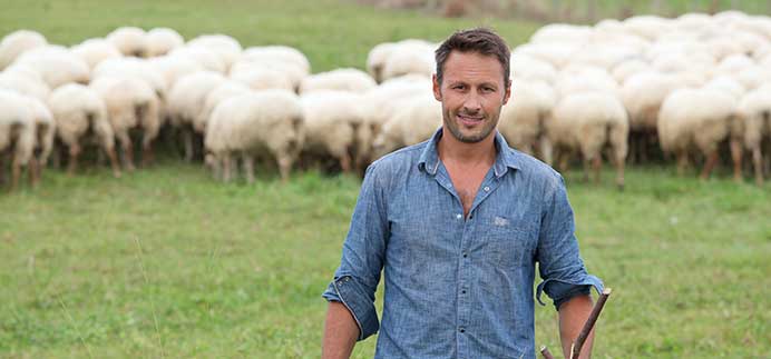 farmer in field with sheep